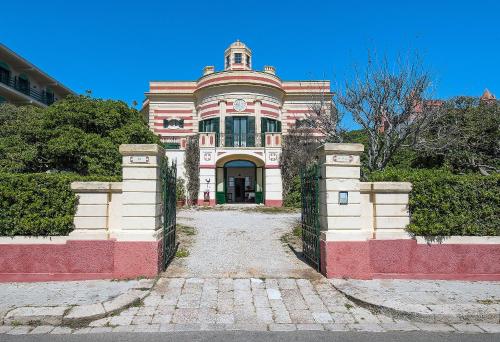 a large house with a gate in front of it at Villa La Meridiana - Caroli Hotels in Leuca