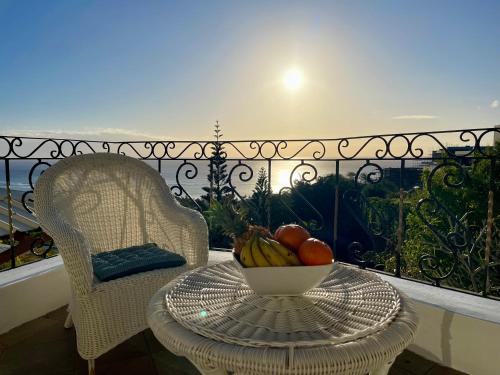 a bowl of fruit on a table on a balcony at Sunset View by JuMa in Rivière Noire