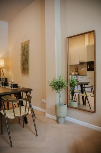 a living room with a table and a mirror at Naest - Authentic Escapes Grand House in Nijmegen