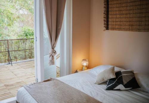 a bedroom with a bed next to a window at Naest - Authentic Escapes Grand House in Nijmegen