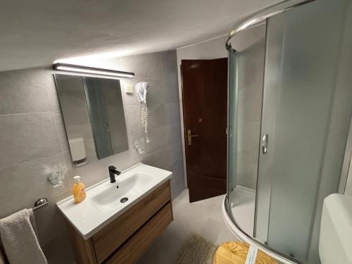a bathroom with a sink and a shower at Rooms Marko Polo in Zadar