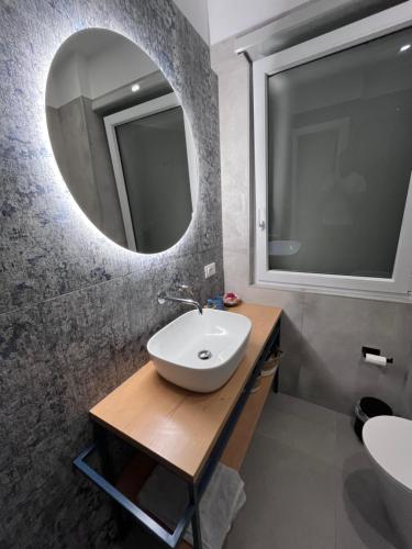 a bathroom with a sink and a mirror at Sole e Sale in Terracina
