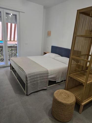 a bedroom with a bed and a chair at Sole e Sale in Terracina