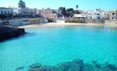 a large body of water with a beach and buildings at DIADEMA Luxury Suite in Nardò