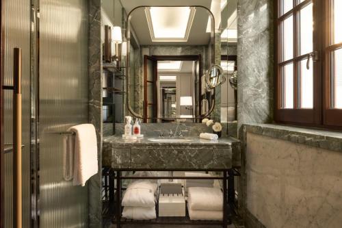a bathroom with a sink and a mirror at Corinthia Rome in Rome