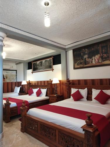 a bedroom with two beds with red pillows at Ella Mount Heaven in Ella