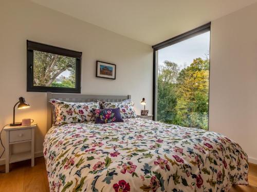 a bedroom with a bed and a large window at 2 Bed in Brecon oc-59734 in Talgarth
