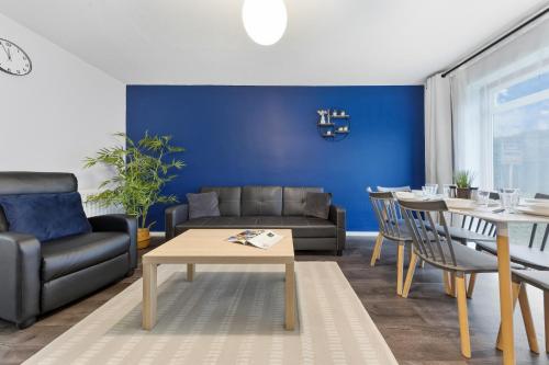 a living room with a couch and a table at 4 Bedroom Fully Furnished House - Longer Stay Offers - Contractor Digs - NEW in Crawley