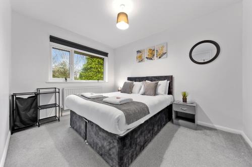 a bedroom with a large bed and a window at 4 Bedroom Fully Furnished House - Longer Stay Offers - Contractor Digs - NEW in Crawley