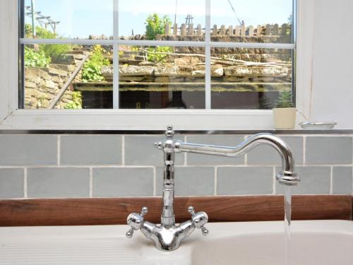 a kitchen sink with a faucet and a window at 2 Bed in High Peak oc-57871 in Hayfield