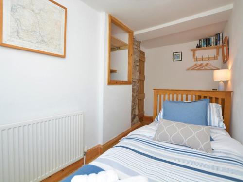 a bedroom with a bed with blue and white sheets at 2 Bed in High Peak oc-57871 in Hayfield