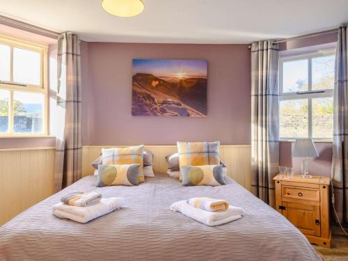 a bedroom with a large bed with towels on it at 2 Bed in Crickhowell oc-90346 in Crickhowell
