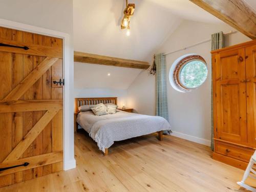 a bedroom with a bed and a wooden door at 3 Bed in Whitchurch oc-88915 in Whixall