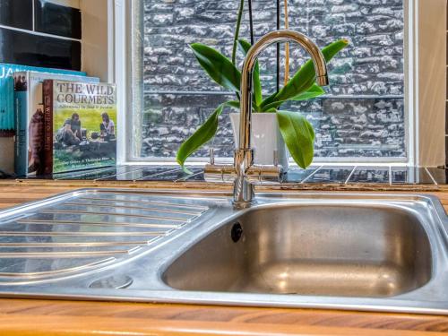 a kitchen sink with a plant in a window at 3 Bed in Buxton oc-77955 in Tideswell