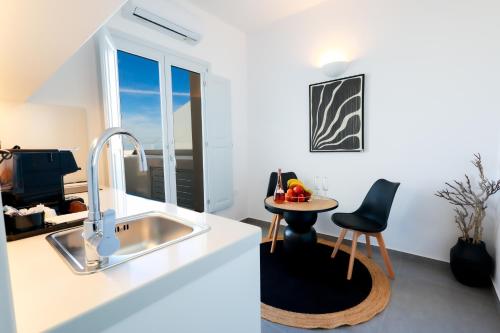 a kitchen with a sink and a table at Stay Lux Suites in Karterados