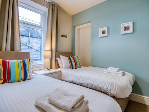 a bedroom with two beds with towels on them at 3 Bed in Buxton oc-77955 in Tideswell