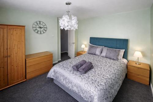 a bedroom with a bed with two purple pillows at Cloverdale in Bedlington