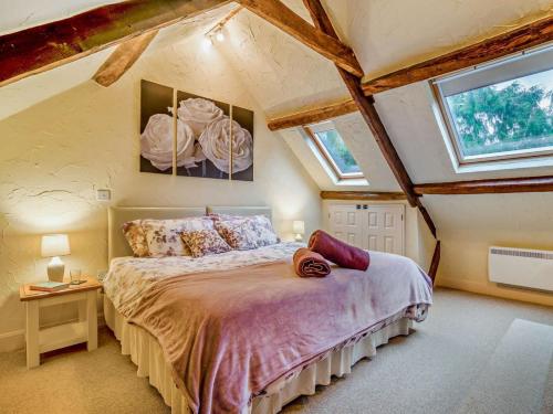 a bedroom with a bed in a room with windows at 2 Bed in Coleford oc-78181 in Symonds Yat