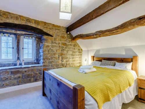 a bedroom with a large bed in a brick wall at 3 Bed in Belper oc-85797 in Crich