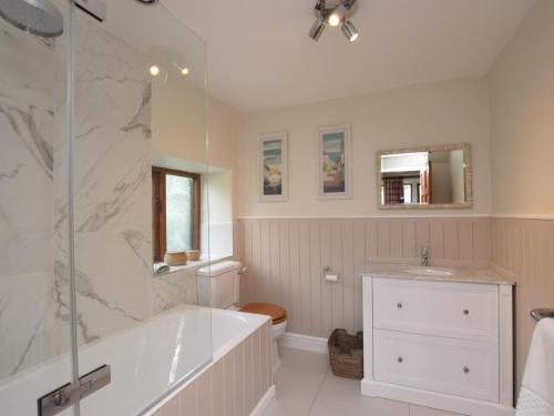 a bathroom with a tub and a toilet and a sink at 8 Bed in Rugeley oc-79321 in Abbots Bromley