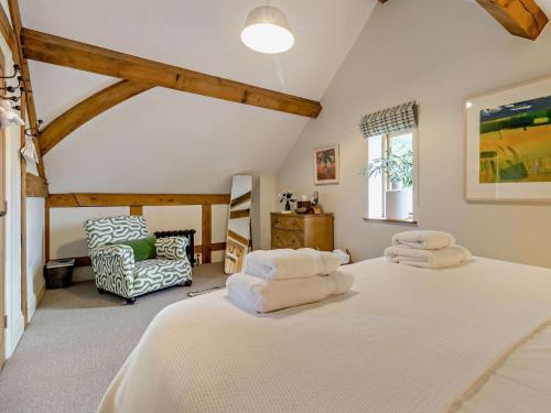 a bedroom with two white beds and a chair at 2 Bed in Hereford oc-82095 in Byford