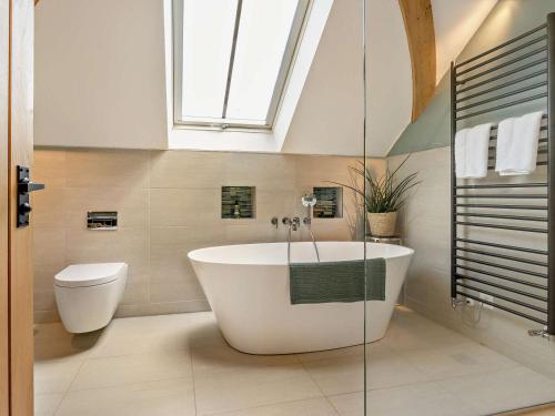 a bathroom with a white tub and a toilet at 2 Bed in Hereford oc-82095 in Byford