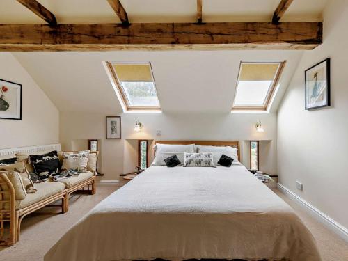 a bedroom with a large bed and two windows at 2 Bed in Dronfield oc-pk612 in Barlow