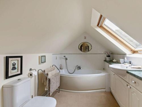 a bathroom with a toilet and a tub and a sink at 2 Bed in Dronfield oc-pk612 in Barlow