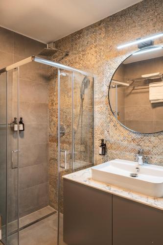 a bathroom with a sink and a shower at Aparthotel Cosy in Stuttgart