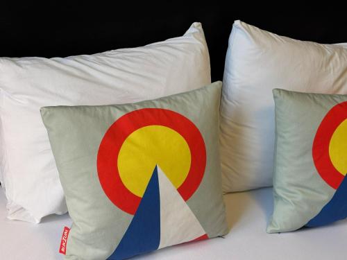 two pillows sitting on top of a bed at Vintage Lovers Antwerp in Antwerp
