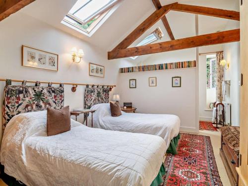 two beds in a room with skylights at 2 Bed in Kington oc-92986 in Lyonshall