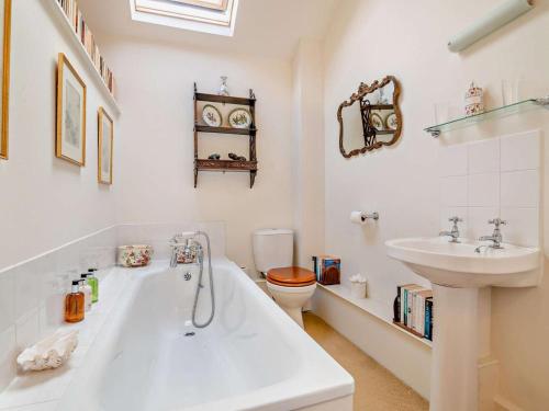 a bathroom with a sink and a tub and a toilet at 2 Bed in Kington oc-92986 in Lyonshall