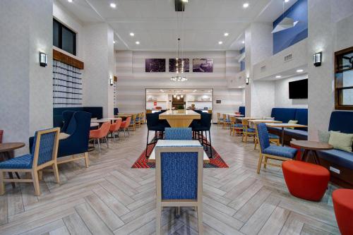 a dining room with tables and chairs and a restaurant at Hampton Inn & Suites Dayton-Vandalia in Murlin Heights