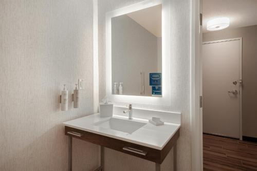 a bathroom with a sink and a large mirror at Hampton Inn & Suites Dayton-Vandalia in Murlin Heights