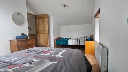 a bedroom with a bed and a dresser and a mirror at Oustal de Piarelle in Saint-Jean-du-Bruel