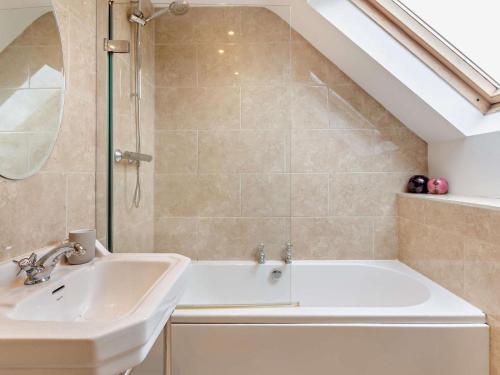 a bathroom with a sink and a bath tub at 4 Bed in Matlock oc-93830 in Crich