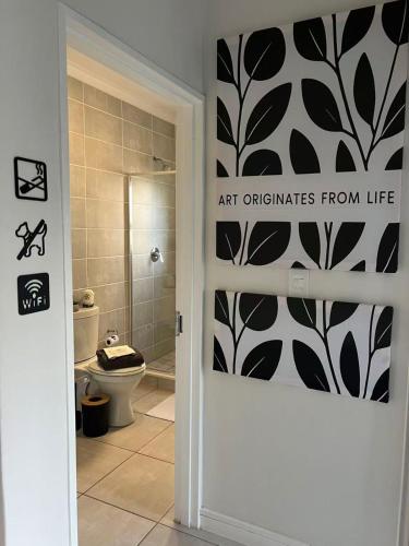 a bathroom with a black and white patterned wall at The Jade, Somerset West in Strand