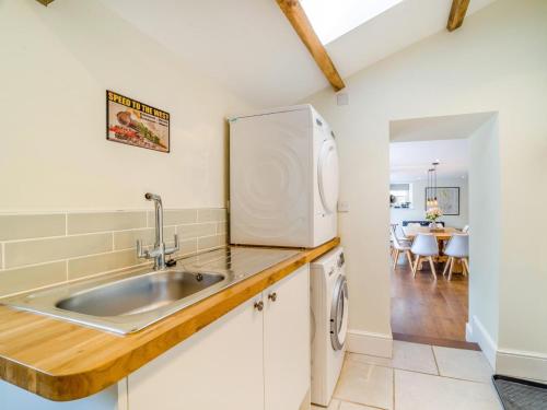 a kitchen with a sink and a refrigerator at 5 Bed in Crickhowell oc-90053 in Crickhowell