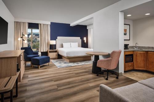 a hotel room with a bed and a desk at Hampton Inn & Suites Destin in Destin