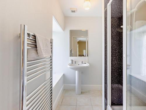 a white bathroom with a sink and a shower at 6 Bed in Okehampton oc-estra in Okehampton