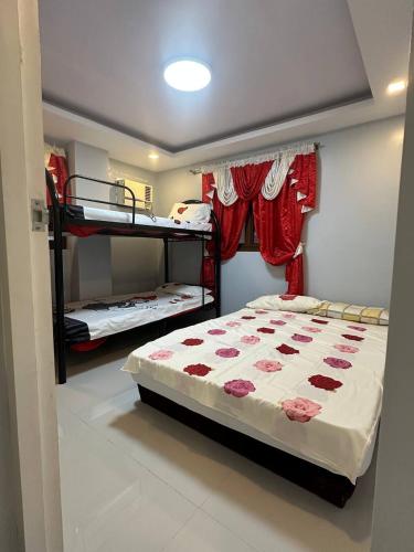 a bedroom with two bunk beds in a room at Koenigs Lodging House in Bocaue