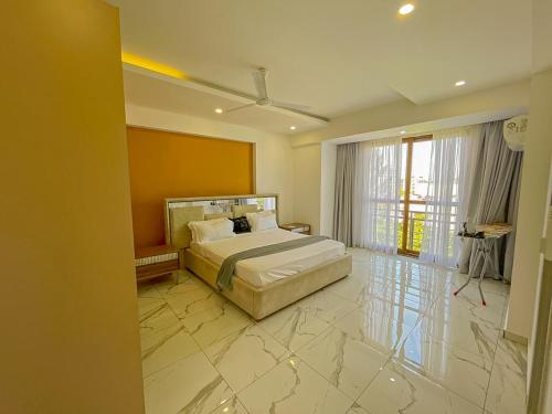 a bedroom with a bed and a large marble floor at Aqua kingstone apartments in Mombasa