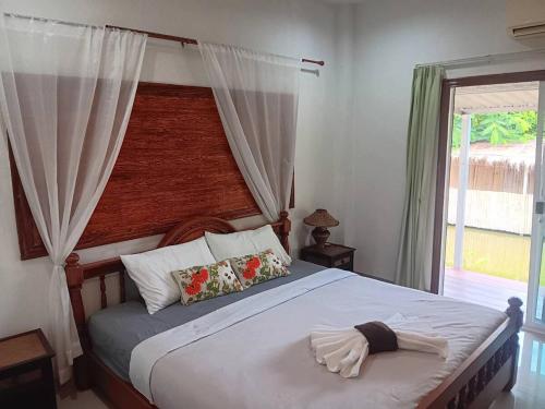 a bedroom with a bed with a towel on it at Baan Farang in Samut Songkhram