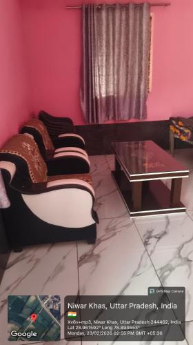 a living room with a couch and a table at Sukhram ji ka awas in Morādābād