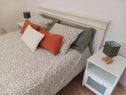 a bedroom with a bed with pillows on it at Tranquil Villa La cabaa Galdar in Gáldar