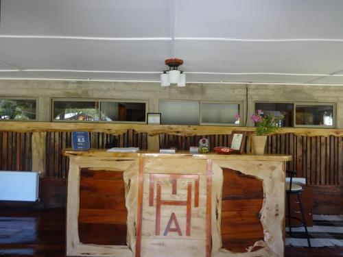 a bar in a room with a wooden wall at Eco Hotel Antuco in Antuco