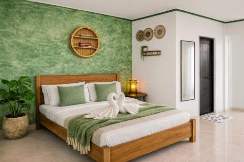a bedroom with a bed with a towel on it at Lelija Apartment in General Luna