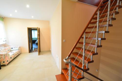 a spiral staircase in a room with a bedroom at Willa Olympia in Unieście