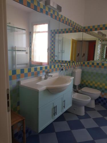 a bathroom with a sink and a toilet and a mirror at B&B Ca' Vecchia in Budrio