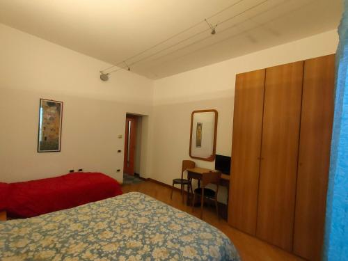 a bedroom with a bed and a dresser and a desk at B&B Ca' Vecchia in Budrio